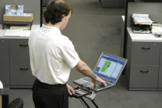 A WLAN surveyor wheels a Wireless Recon&trade; system through a facility to collect and interpret location and radio signal data.